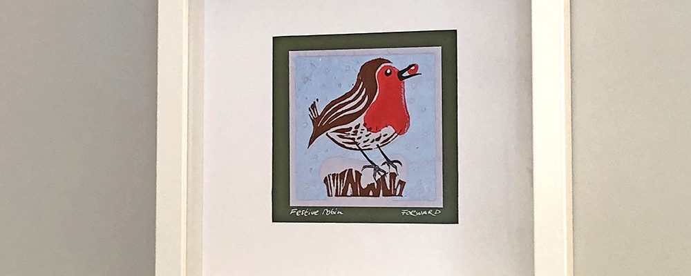 Festive Robin lino print framed on wall