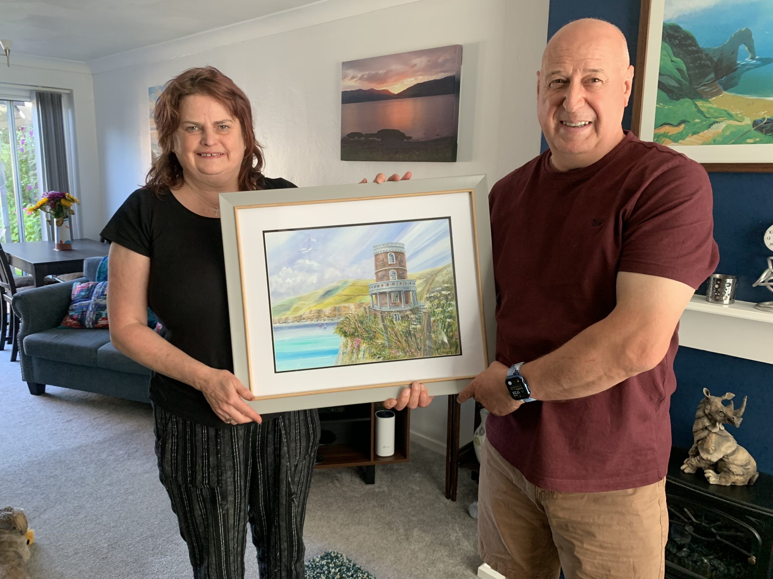 Mr and Mrs Morgan with their newly commissioned painting 'Clavell Tower - the original' painted by Shaun Forward